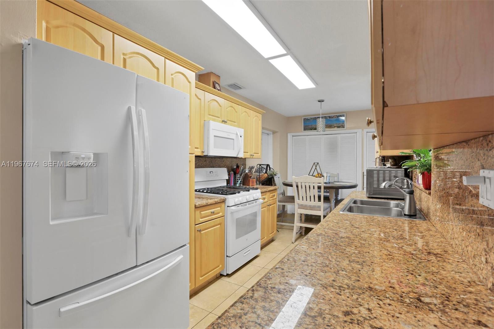 1901 Southwest 90th Avenue Miami, FL 33165 - Photo 14 of 25 a kitchen with white cabinets and appliances
