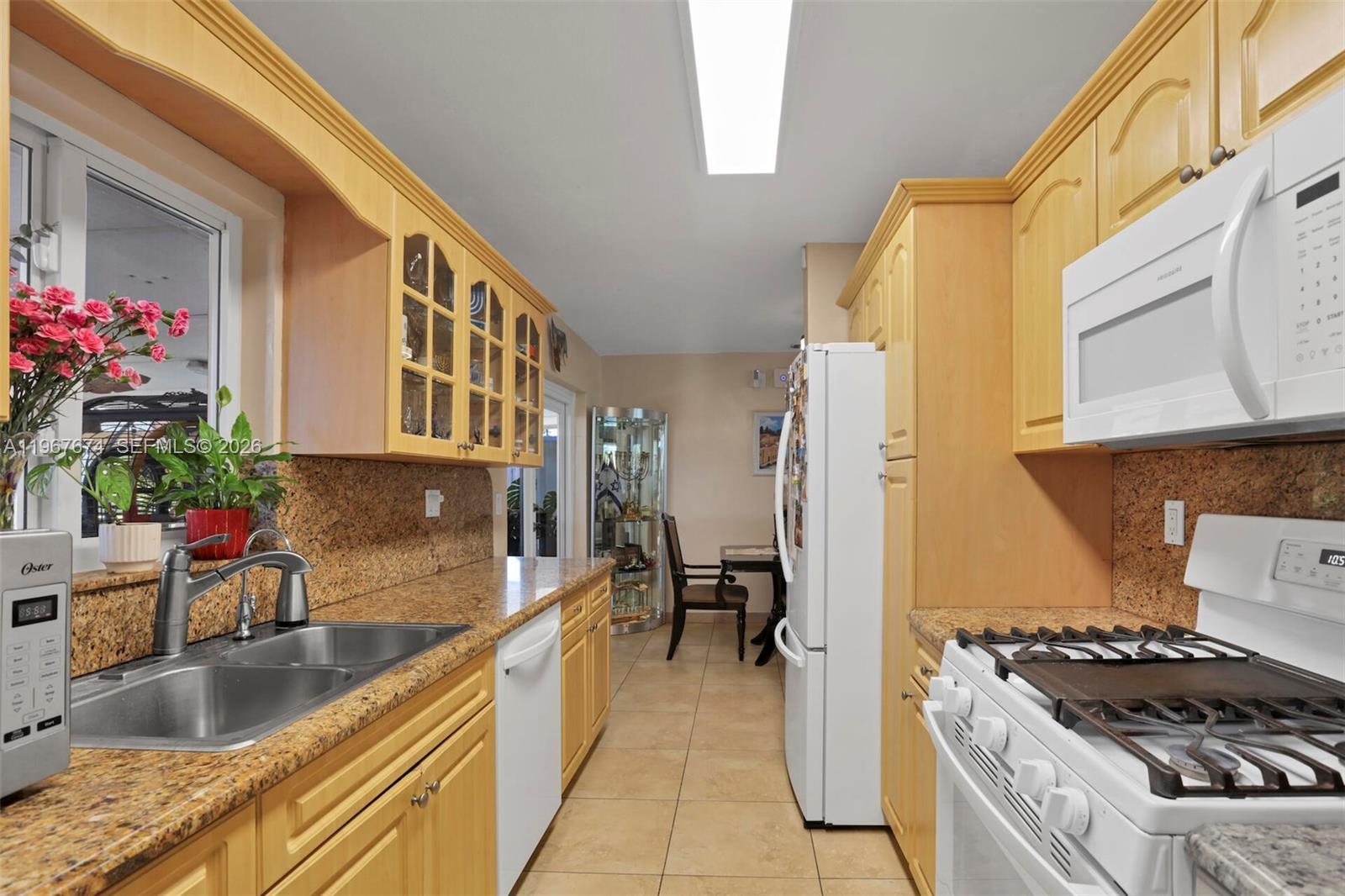 1901 Southwest 90th Avenue Miami, FL 33165 - Photo 15 of 25 a kitchen with stainless steel appliances granite countertop a sink stove and refrigerator