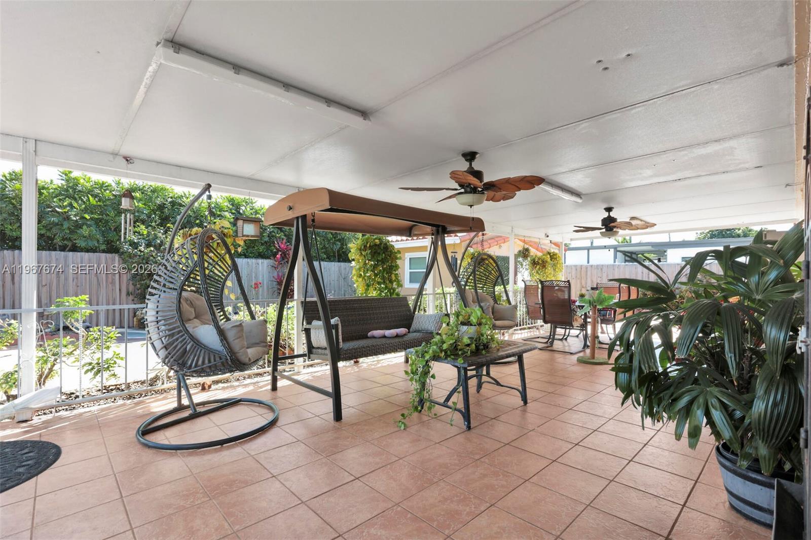 1901 Southwest 90th Avenue Miami, FL 33165 - Photo 18 of 25 a living room with patio furniture and a potted plants