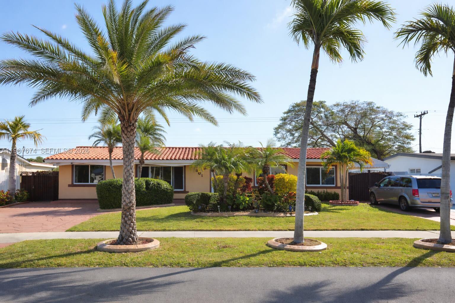1901 Southwest 90th Avenue Miami, FL 33165 - Photo 2 of 25 a front view of a house with garden and palm tree