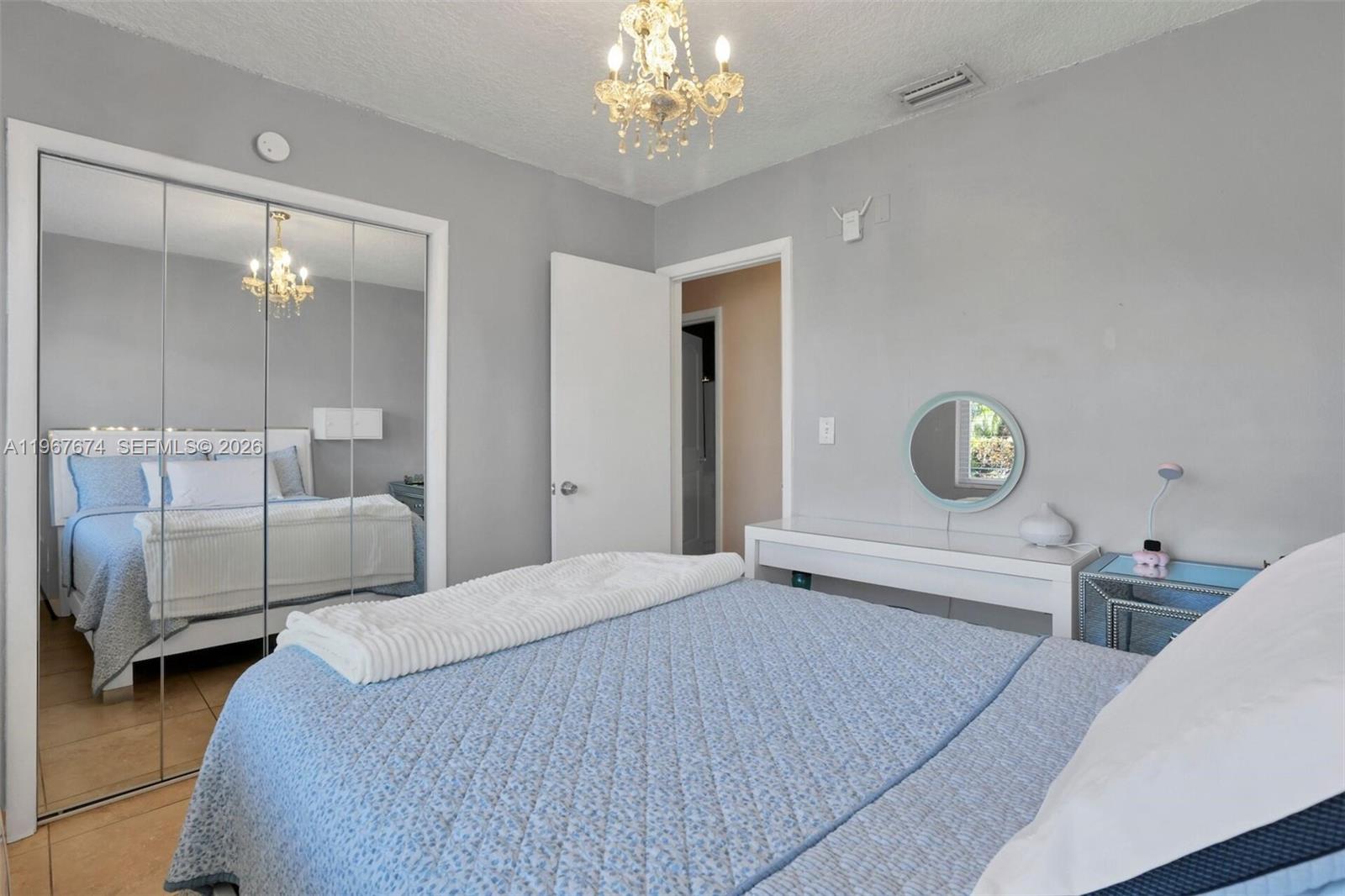 1901 Southwest 90th Avenue Miami, FL 33165 - Photo 6 of 25 a bedroom with a bed and a chandelier