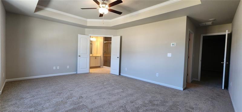 1476 Fern Ridge Lane Norcross, GA 30093 - Photo 13 of 19 an empty room with closet and a chandelier fan