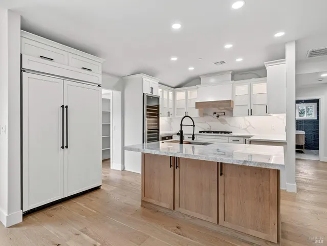 a kitchen with a stove and white cabinets