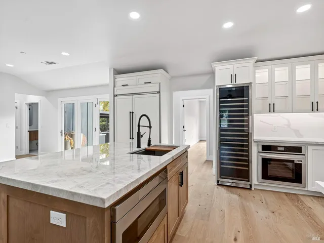 a kitchen with granite countertop cabinets and window