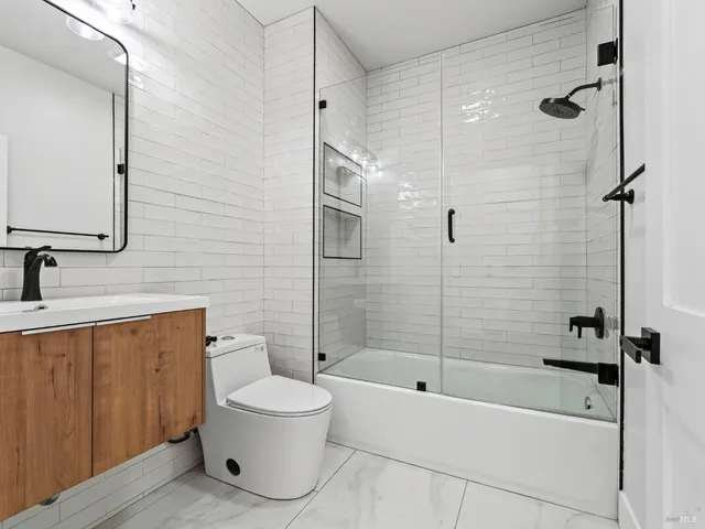 a spacious bathroom with a sink a mirror and a bathtub