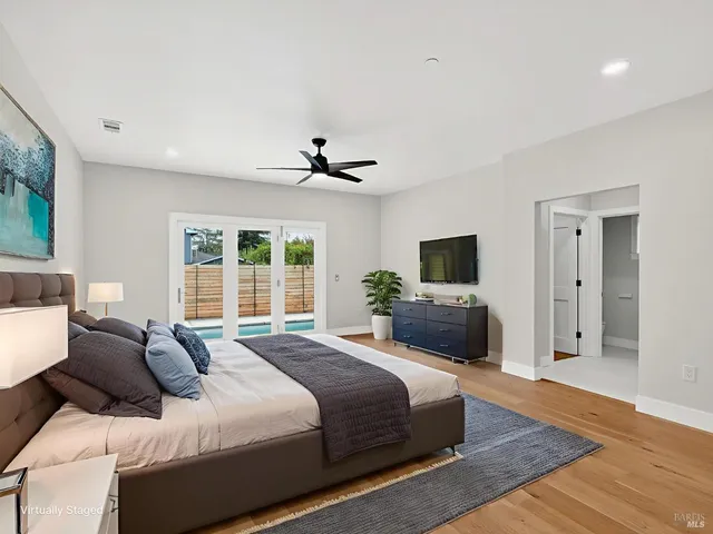 a bathroom with a double vanity sink a mirror and a bathtub