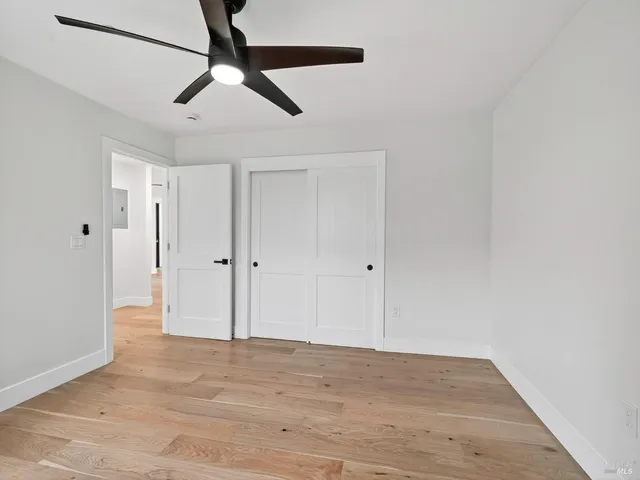 a view of a patio with table and chairs with wooden floor and fence