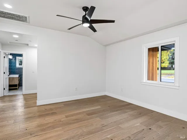 a front view of a house with parking space and a car parked in garage
