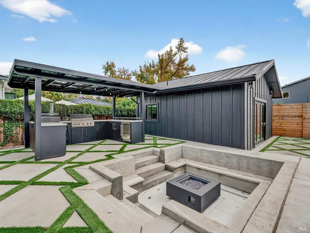 an aerial view of a house with a swimming pool yard and outdoor seating