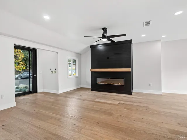 a view of an empty room with a ceiling fan and a window