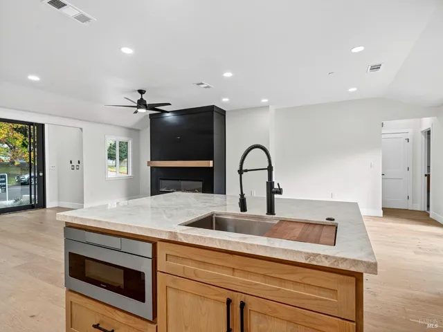 a kitchen with stainless steel appliances granite countertop a stove and a refrigerator