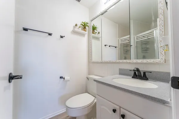 a bathroom with a sink toilet and shower