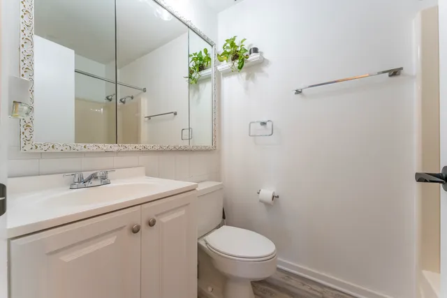 a bathroom with a sink toilet and mirror