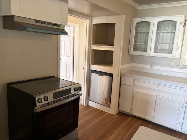 a kitchen with granite countertop a stove and a sink