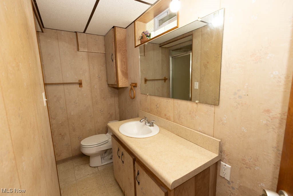 7312 Ivandale Road Independence, OH 44131 - Photo 28 of 44 Bathroom with tile patterned floors, a textured ceiling, vanity, and toilet