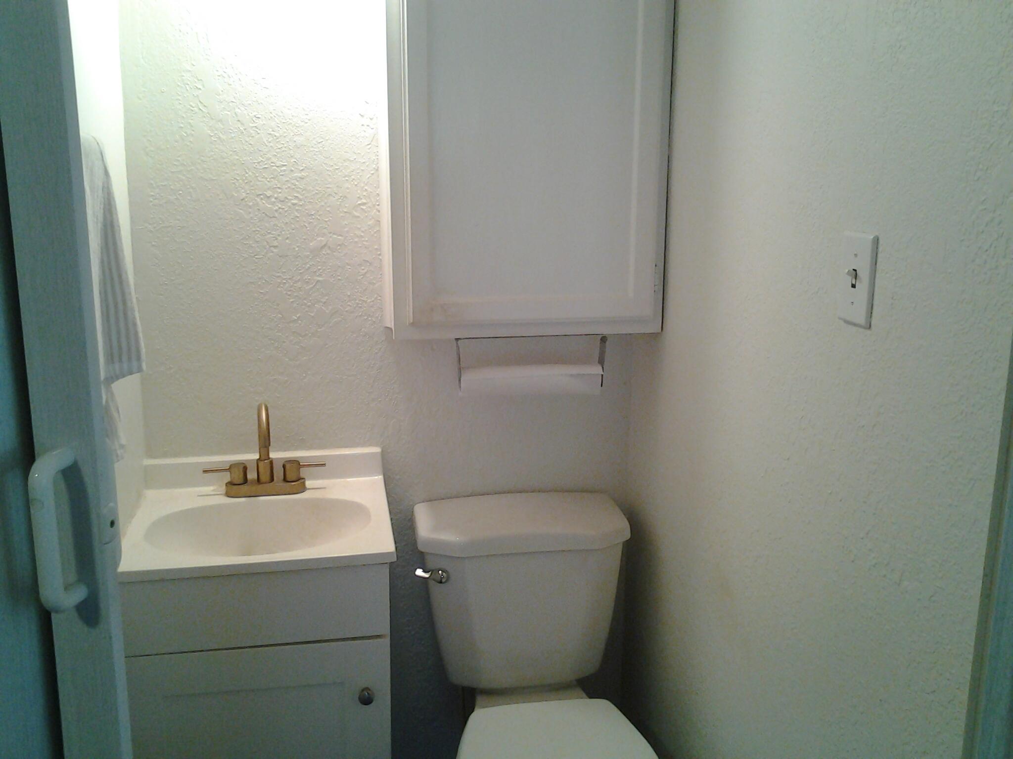 500 8th Street O'Donnell, TX 79351 - Photo 12 of 14 a bathroom with a toilet sink and mirror