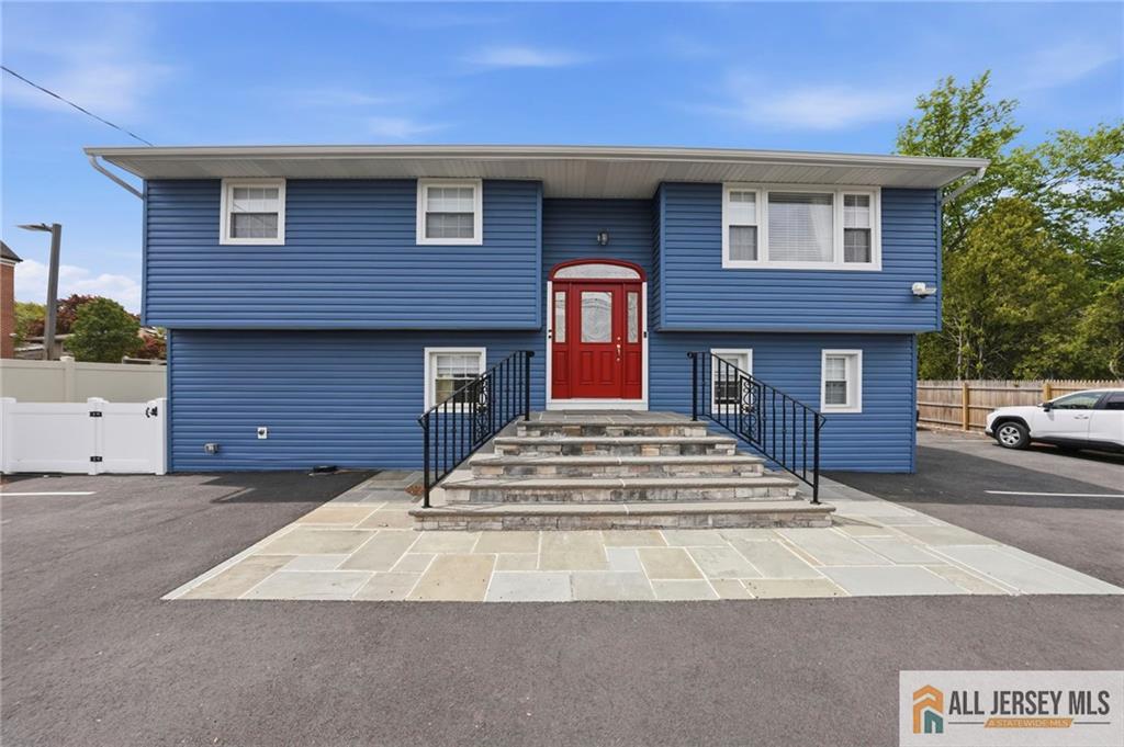 1084 Stelton Road Piscataway, NJ 08854 - Photo 1 of 20 a front view of a house with a yard