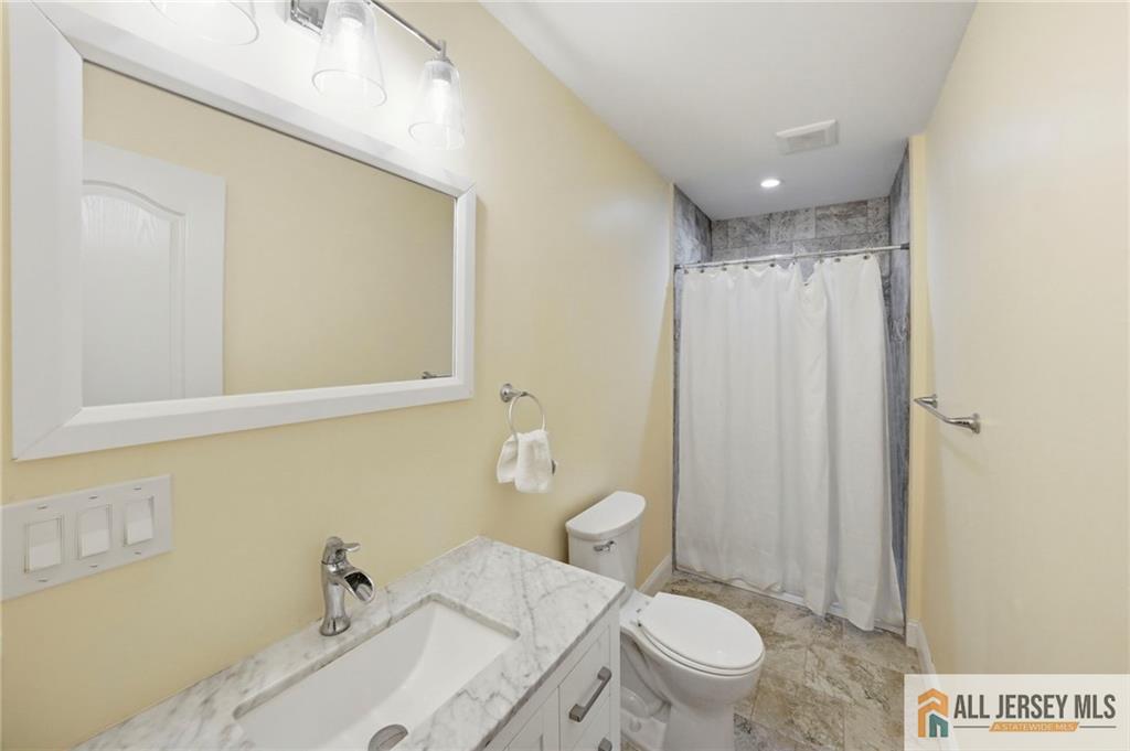 1084 Stelton Road Piscataway, NJ 08854 - Photo 11 of 20 a bathroom with a sink toilet and shower