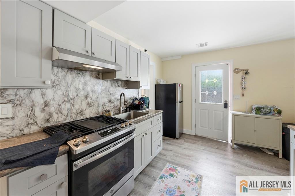 1084 Stelton Road Piscataway, NJ 08854 - Photo 12 of 20 a kitchen with a stove and a refrigerator