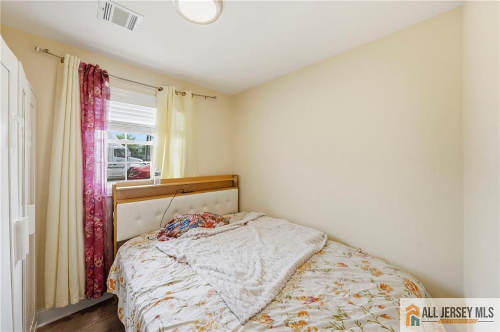 1084 Stelton Road Piscataway, NJ 08854 - Photo 15 of 20 a bedroom with a bed and a window