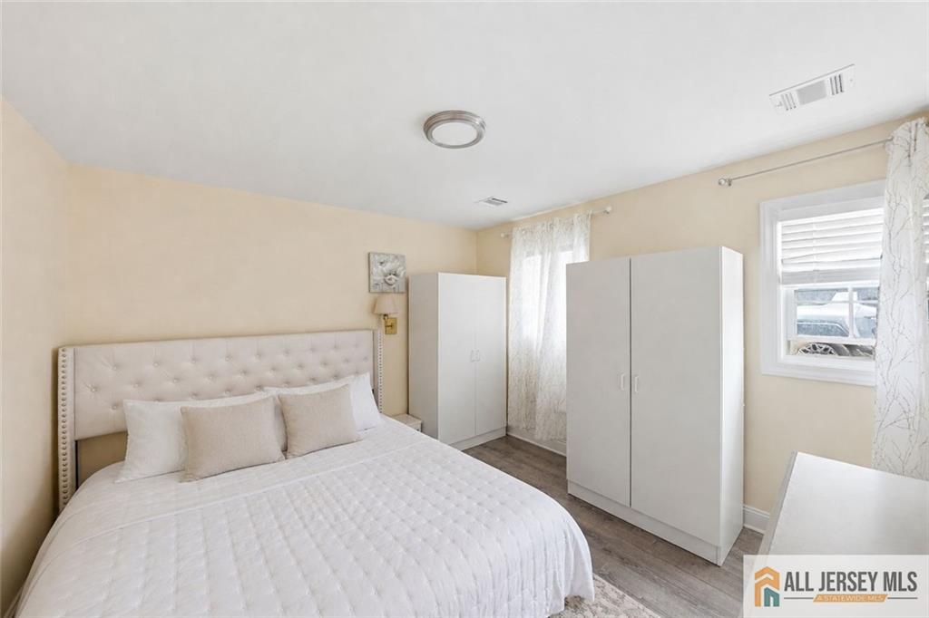 1084 Stelton Road Piscataway, NJ 08854 - Photo 16 of 20 a bedroom with a bed and a refrigerator