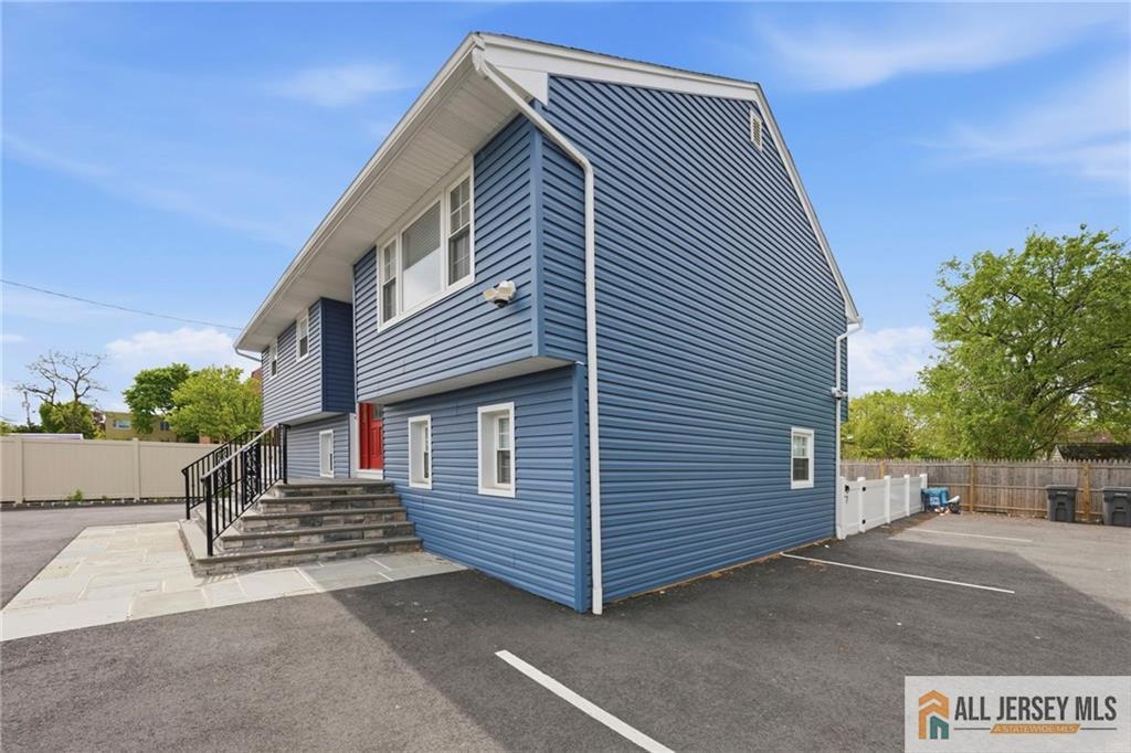 1084 Stelton Road Piscataway, NJ 08854 - Photo 2 of 20 a front view of a house with a garage