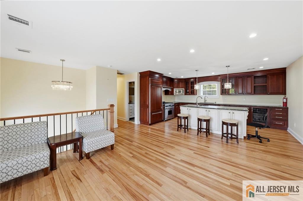 1084 Stelton Road Piscataway, NJ 08854 - Photo 6 of 20 a view of a kitchen with dining room and wooden floor