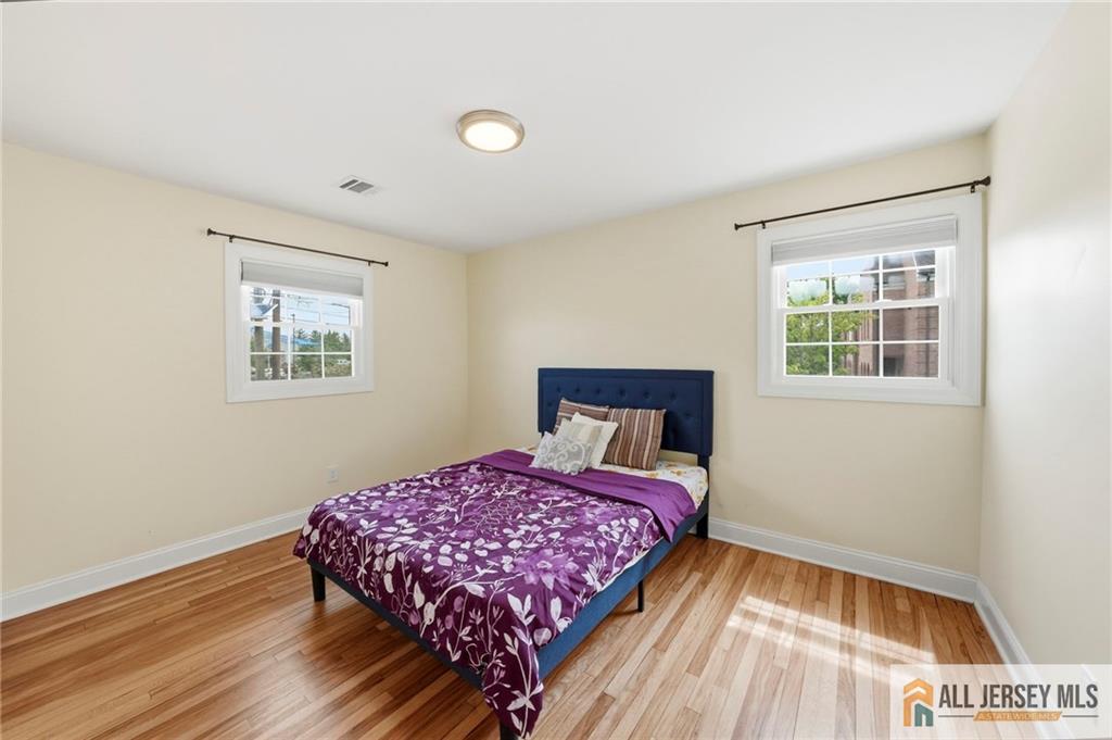 1084 Stelton Road Piscataway, NJ 08854 - Photo 9 of 20 a bedroom with a bed and a window
