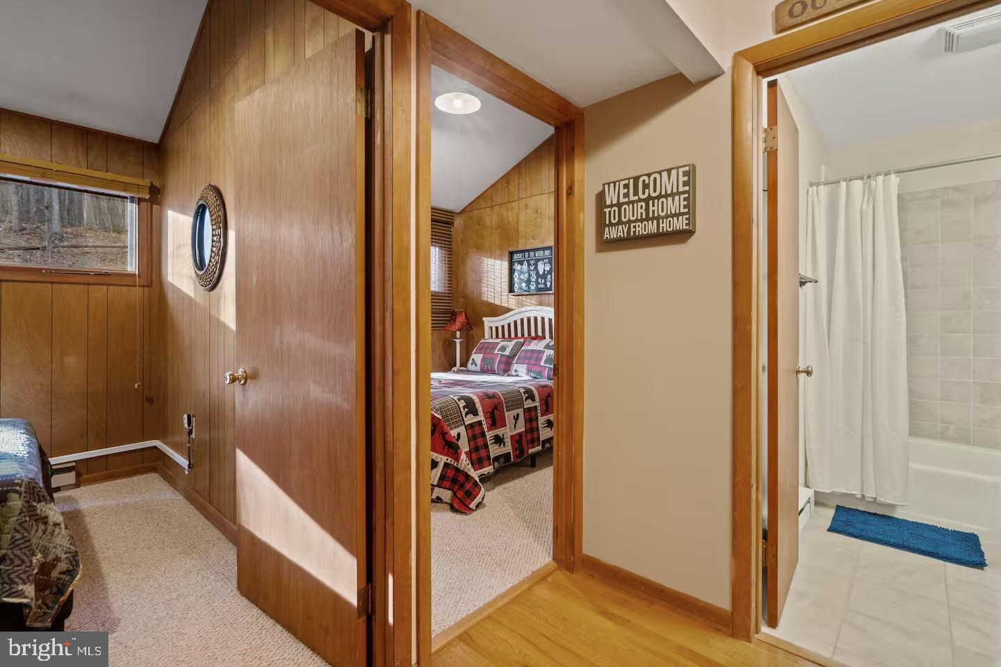 170 Whipporwill Way Berkeley Springs, WV 25411 - Photo 12 of 32 a view of a hallway with wooden floor and a bathroom