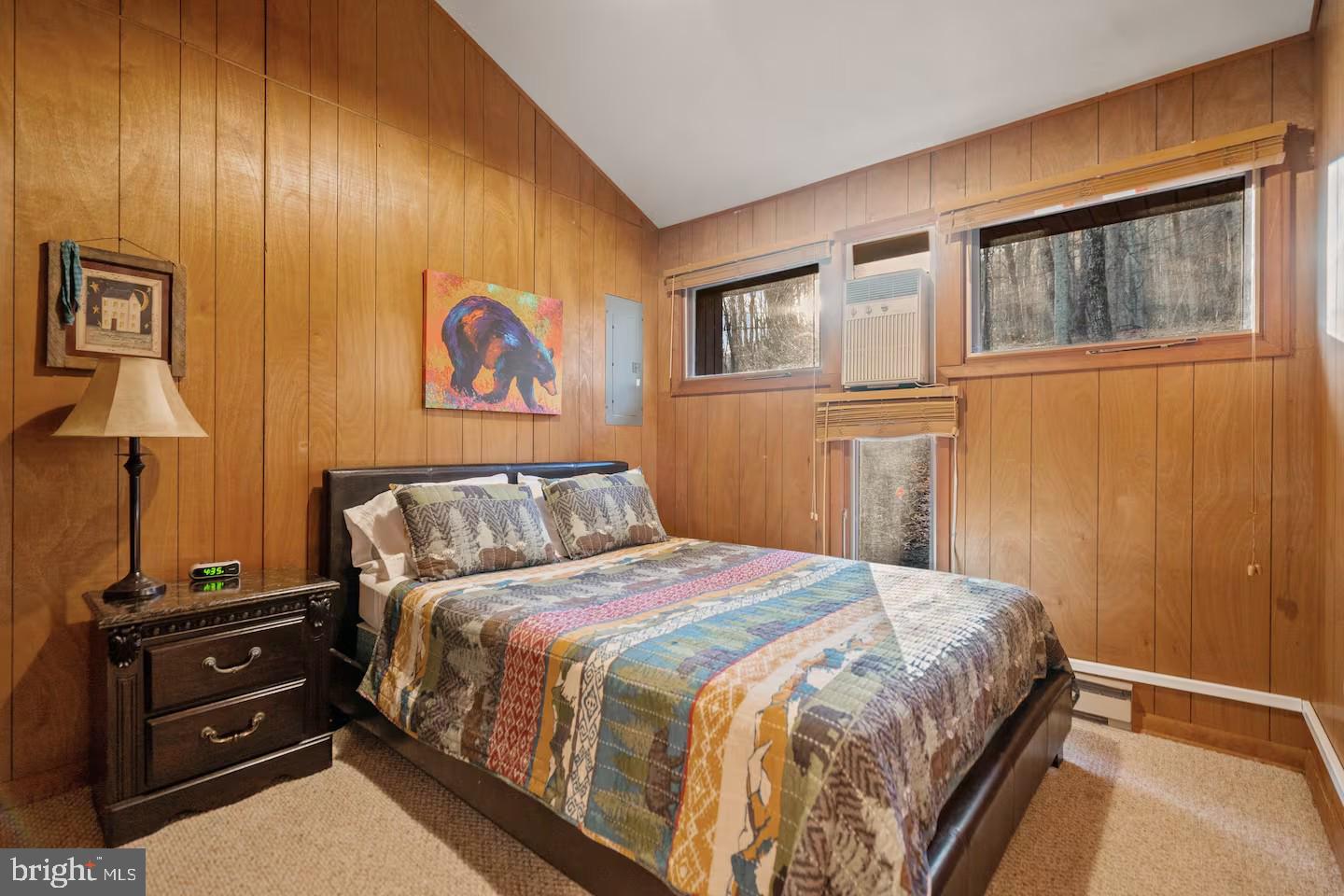 170 Whipporwill Way Berkeley Springs, WV 25411 - Photo 14 of 32 a bedroom with a bed and a lamp on dresser
