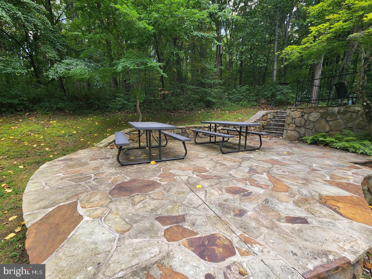 170 Whipporwill Way Berkeley Springs, WV 25411 - Photo 23 of 32 a backyard of a house with table and chairs