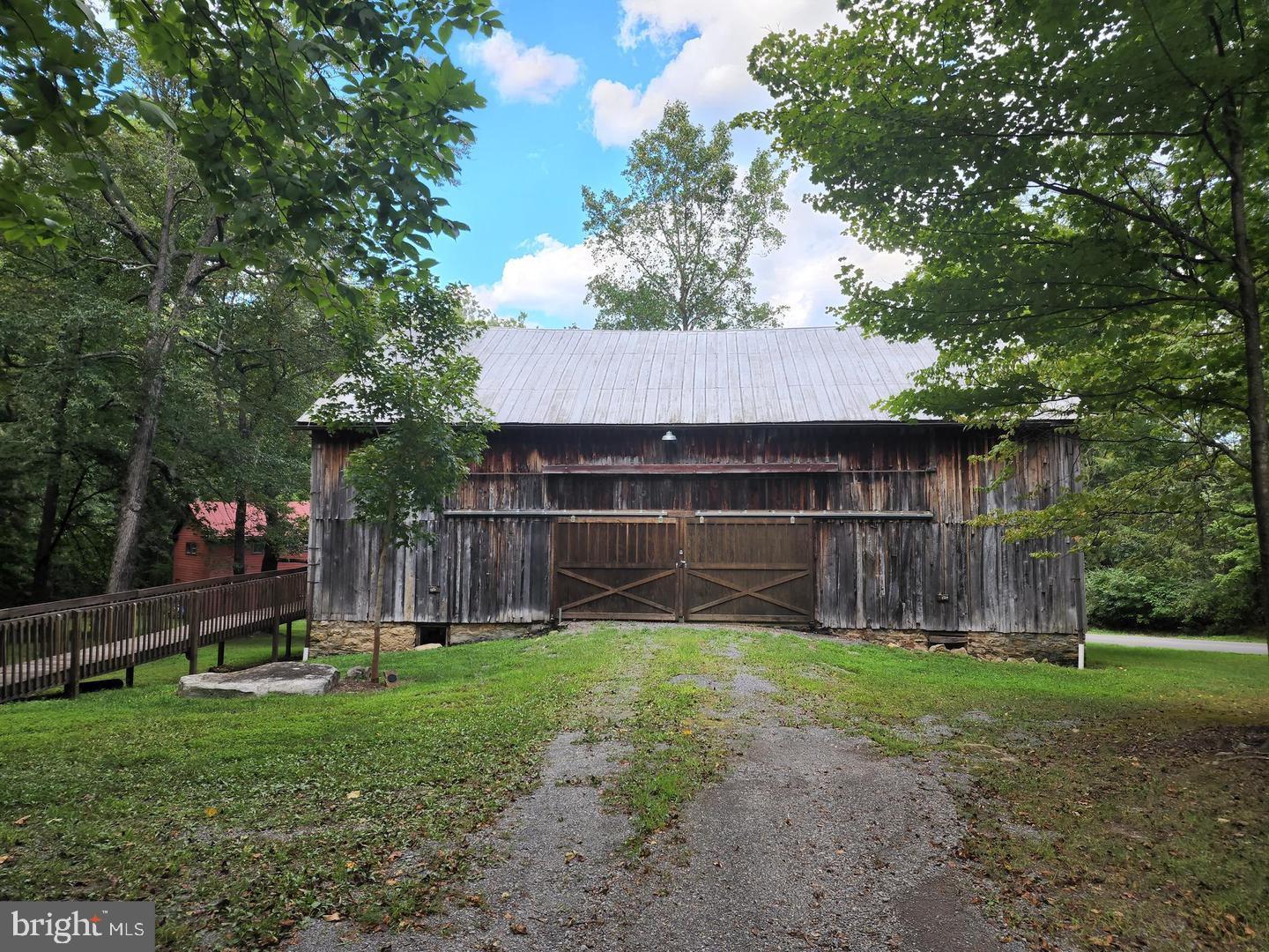 170 Whipporwill Way Berkeley Springs, WV 25411 - Photo 26 of 32 a view of a backyard with a cabin and a large tree