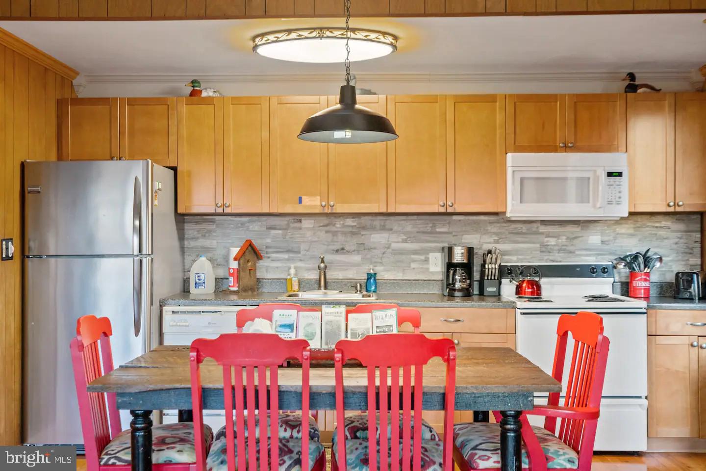 170 Whipporwill Way Berkeley Springs, WV 25411 - Photo 5 of 32 a kitchen with stainless steel appliances a stove a refrigerator and a dining table