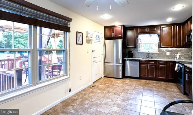 a kitchen with stainless steel appliances granite countertop a refrigerator and a sink