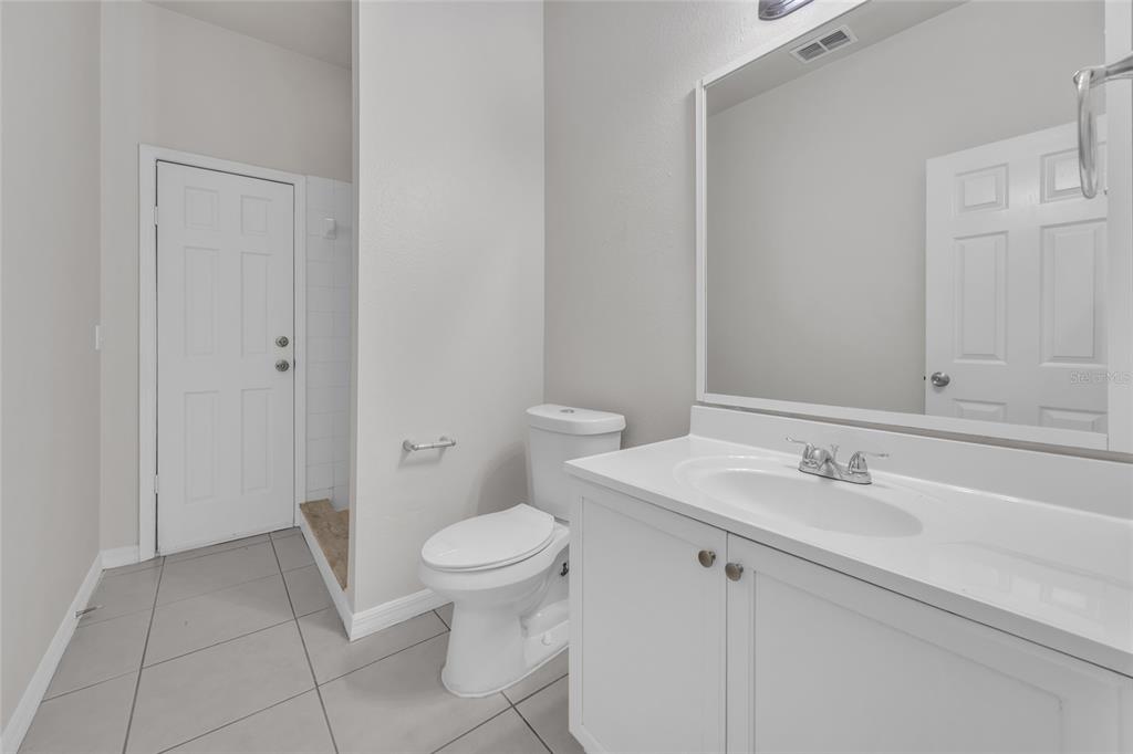 1047 Durango Loop Street Davenport, FL 33897 - Photo 16 of 35 a bathroom with a sink toilet and vanity