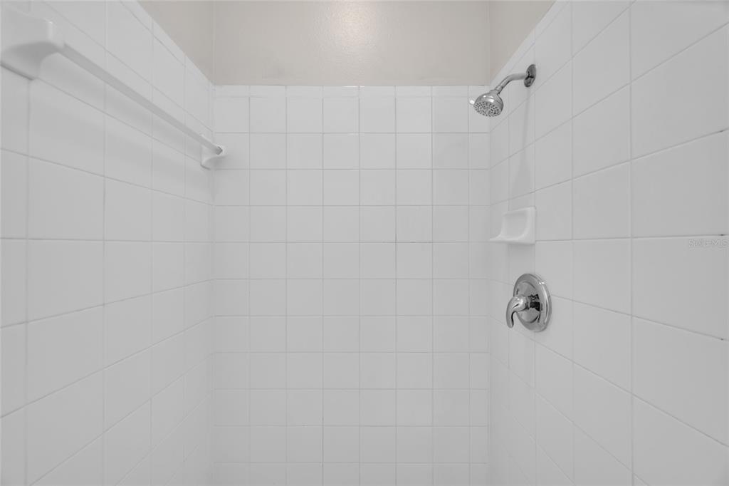 1047 Durango Loop Street Davenport, FL 33897 - Photo 17 of 35 a bathroom with a shower