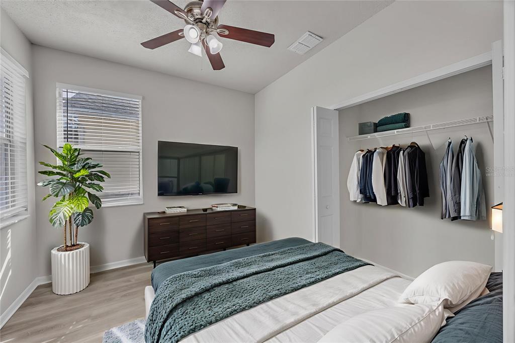 1047 Durango Loop Street Davenport, FL 33897 - Photo 18 of 35 a bedroom with a bed and a television