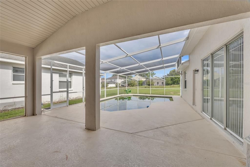 1047 Durango Loop Street Davenport, FL 33897 - Photo 26 of 35 a view of a porch with furniture and floor to ceiling window