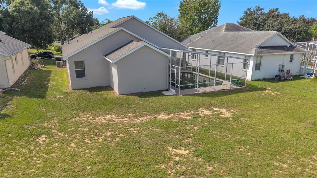 1047 Durango Loop Street Davenport, FL 33897 - Photo 29 of 35 a view of a house with a yard and garage