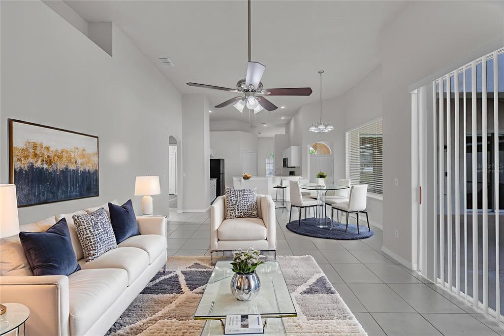 1047 Durango Loop Street Davenport, FL 33897 - Photo 8 of 35 a living room with furniture and a chandelier