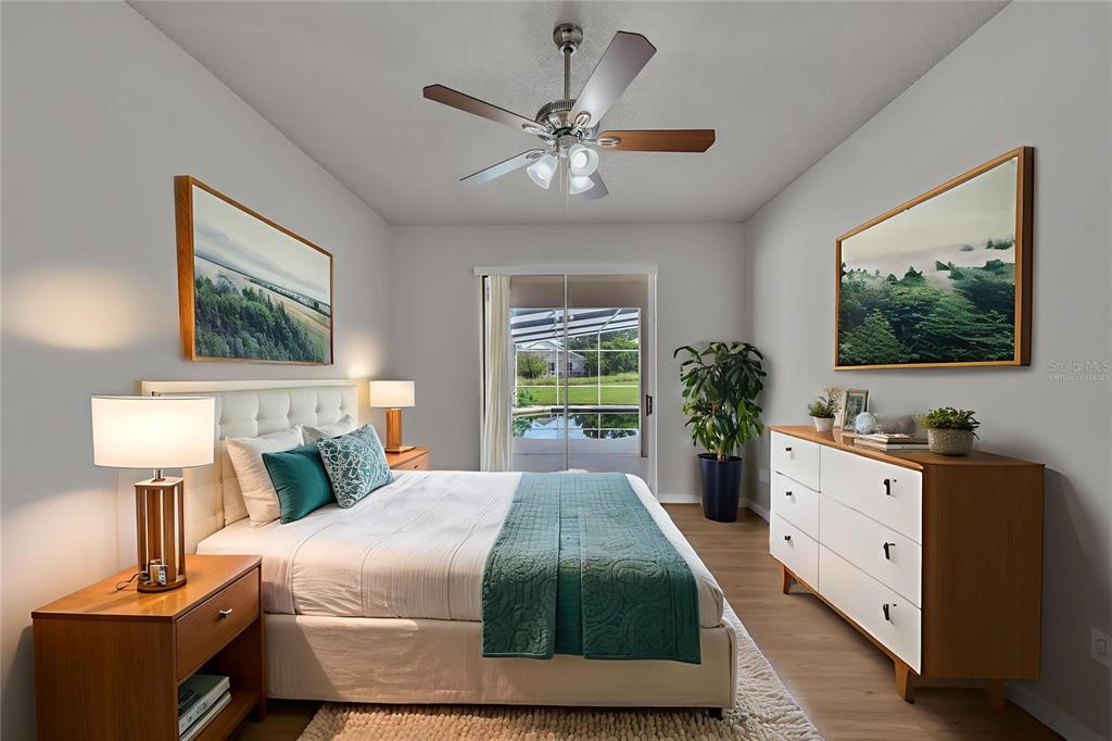 1047 Durango Loop Street Davenport, FL 33897 - Photo 10 of 35 a bedroom with a large bed and a chandelier