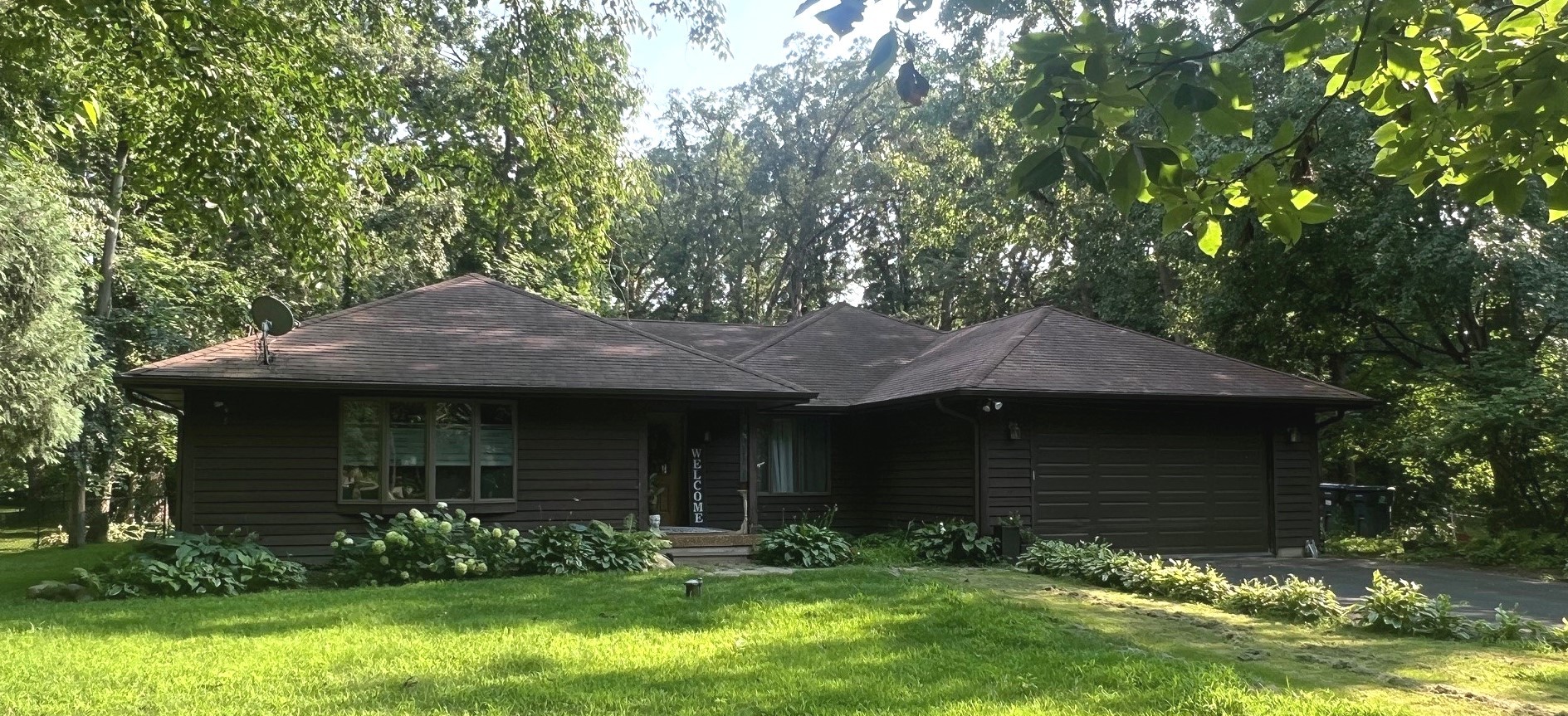 12970 Briody Way Genoa, IL 60135 - Photo 3 of 45 a front view of a house with a garden and yard