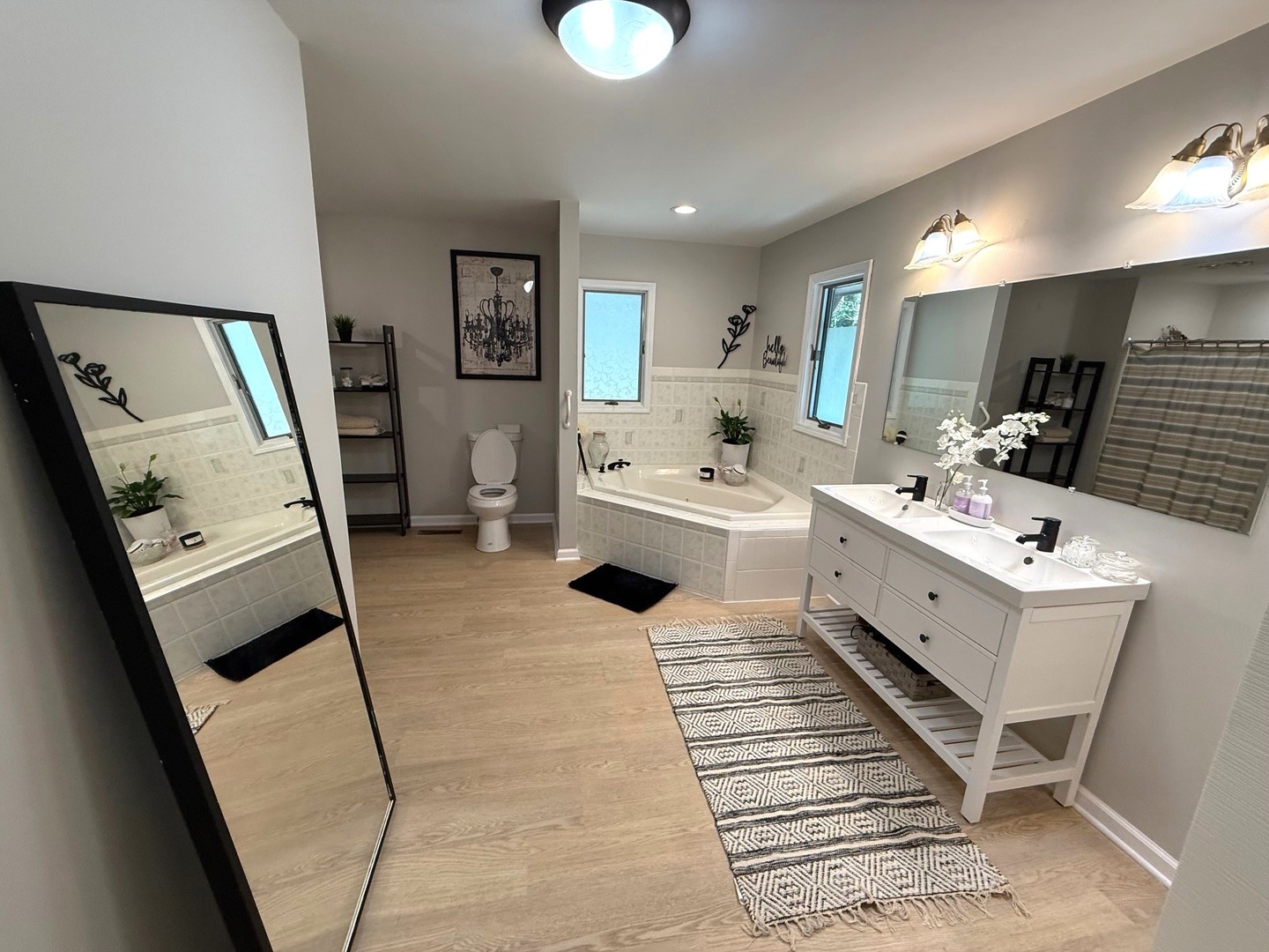 12970 Briody Way Genoa, IL 60135 - Photo 39 of 45 a bathroom with a double vanity sink a mirror and a bathtub
