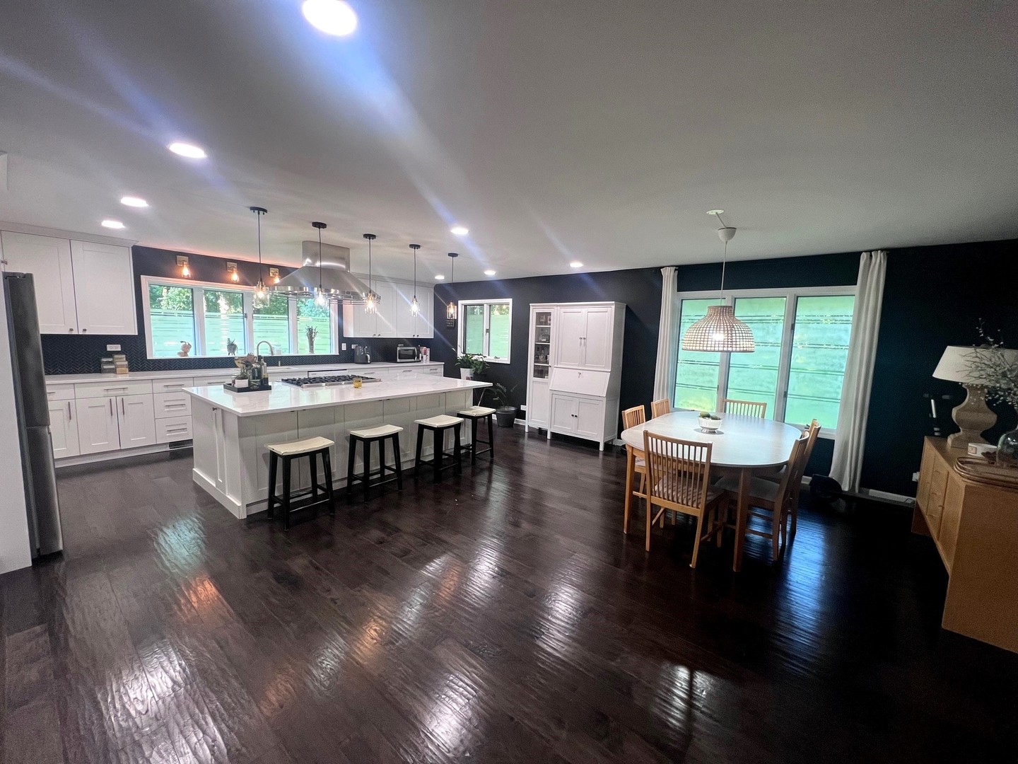 12970 Briody Way Genoa, IL 60135 - Photo 7 of 45 a large dining hall with stainless steel appliances granite countertop a stove oven a dining table and chairs with wooden floor