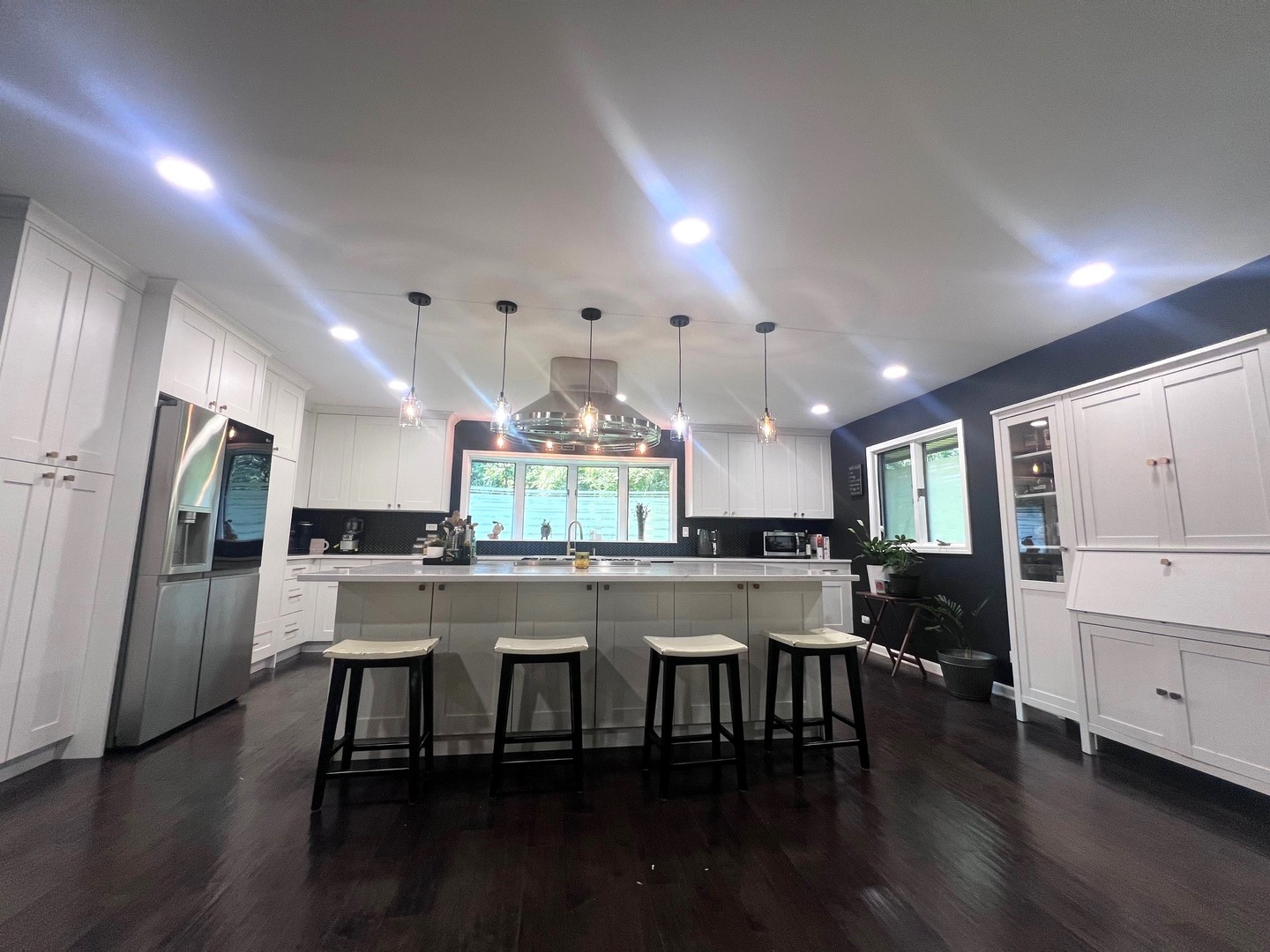 12970 Briody Way Genoa, IL 60135 - Photo 9 of 45 a kitchen with stainless steel appliances a dining table chairs and wooden floor