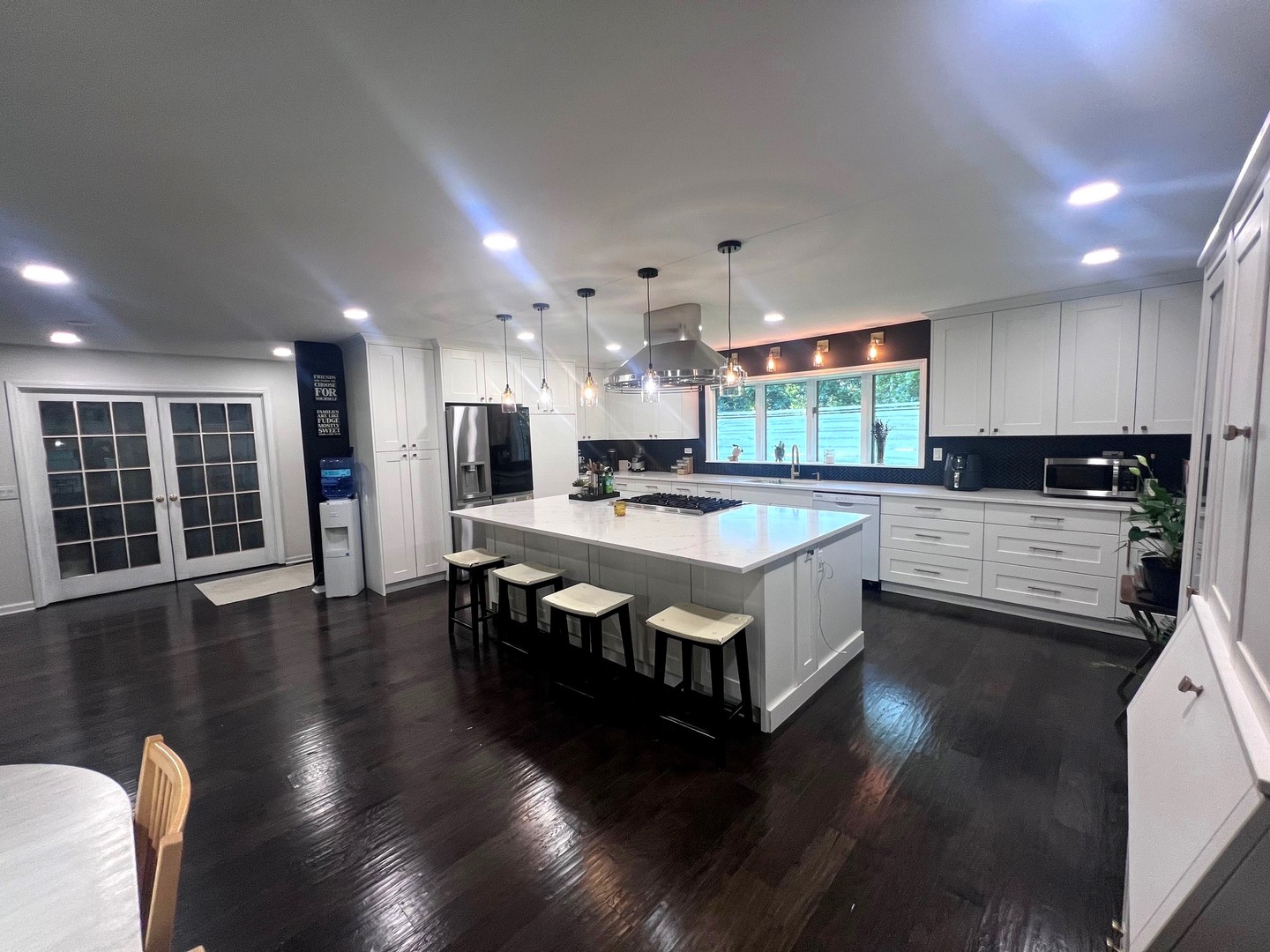 12970 Briody Way Genoa, IL 60135 - Photo 10 of 45 a large kitchen with stainless steel appliances granite countertop a large stove a sink a large island with chairs and wooden floor