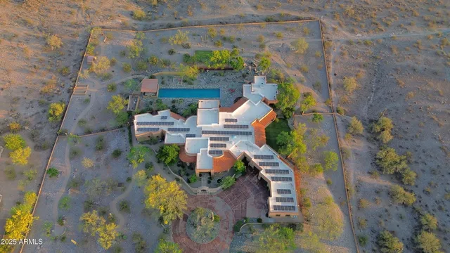 an aerial view of a house with a yard