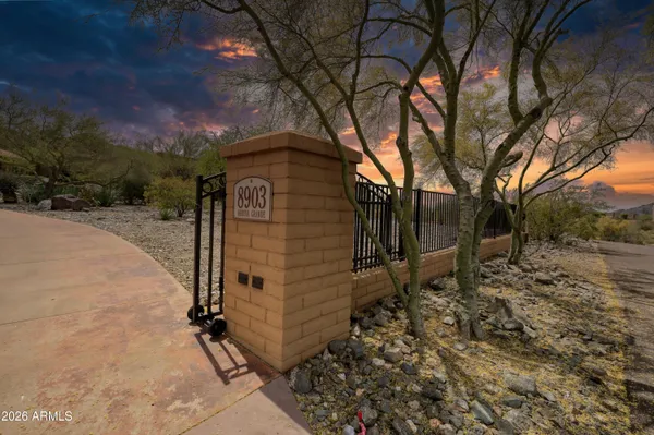 an aerial view of a house with a yard and lake view