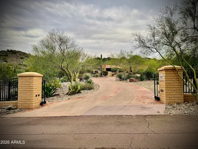 an aerial view of a house with a yard and lake view