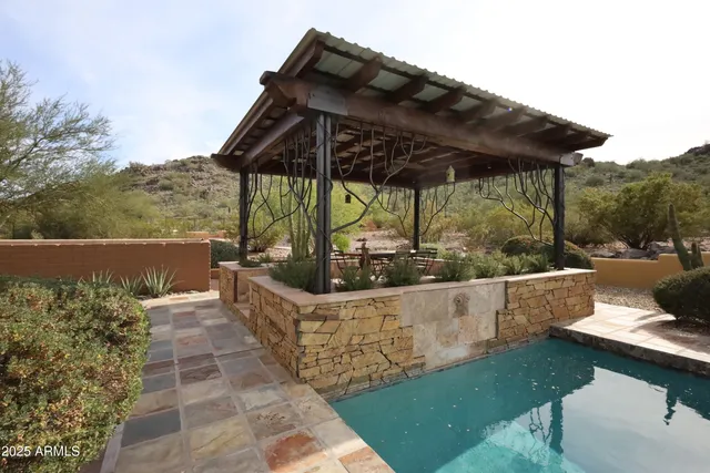 a view of an empty room with window and mirror